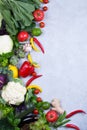 Frame of fresh organic vegetables on a gray concrete background . Healthy natural food top view, copy space . Royalty Free Stock Photo