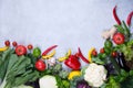 Frame of fresh organic vegetables on a gray concrete background . Healthy natural food top view, copy space . Royalty Free Stock Photo