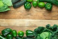 Frame from Fresh Raw Organic Green Vegetables Savoy Cabbage Zucchini Cucumbers Bell Peppers Avocados on Weathered Plank Barn Wood