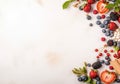 Frame of fresh ripe rowan berries and green leaves on white wooden table, flat lay. Space for text