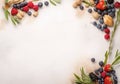 Frame of fresh ripe rowan berries and green leaves on white wooden table, flat lay. Space for text