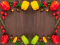 Frame of fresh vegetables, bell peppers, cherry tomatoes, basil and parsley leaves with copy space Royalty Free Stock Photo