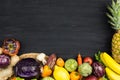 FRAME OF FRESH VEGETABLES AND FRUIT ON BLACK CHALK BACKGROUND. C