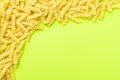 Frame from fusilli type of pasta on green background with space for text Royalty Free Stock Photo