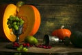 The frame of the gifts of autumn pumpkins, corn, fall leaves, tomatoes, red berry cranberry and grape. Royalty Free Stock Photo