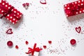 Frame of gifts, confetti, candles and hearts on a white background. The background of Valentine`s day