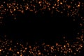 Frame of golden glitter sparkle bubbles particles stars on black background, event festive happy new year holiday