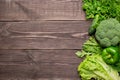 Frame of green fresh vegetables on wooden background, top view Royalty Free Stock Photo