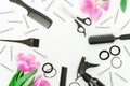 Frame with hairdresser tools - spray, scissors, combs, barrette and tulips flowers on white background. Flat lay, top view Royalty Free Stock Photo