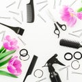 Frame with hairdresser tools - spray, scissors, combs, barrette and tulips on white background. Flat lay, top view Royalty Free Stock Photo