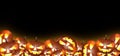 Frame for Halloween text with a lot of Jack O Lanterns pumpkins with spooky face Glowing candles inside. Black Royalty Free Stock Photo