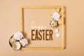 Frame with Happy Easter text and eggs composition decorated with twigs and flowers. Easter greeting card Royalty Free Stock Photo