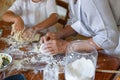 Frame image of the hands of an old woman and a child kneading dough, top view of the dough. Royalty Free Stock Photo