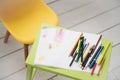 A frame with a kid drowing and colored pencils Royalty Free Stock Photo