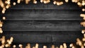 Frame of lights bokeh golden flares, isolated on rustic dark black wooden texture - Christmas Holiday New Year`s Eve Silvester Ne Royalty Free Stock Photo