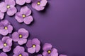 Frame made of beautiful purple pansy flowers on dark violet background with copy space Royalty Free Stock Photo