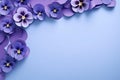 Frame made of beautiful purple pansy flowers on light violet background with copy space. Royalty Free Stock Photo