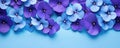 Frame made of beautiful violet and purple pansy flowers on light blue background with copy space. Royalty Free Stock Photo