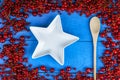 Frame made of berries with plate and wooden spoon Royalty Free Stock Photo