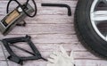 The frame is made of a car jack, wheel, tire air pump, work gloves and socket wrench on a wooden background. Royalty Free Stock Photo