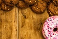 Frame made of chocolate chip cookies, biscuits and colorful donuts top view with copy space Royalty Free Stock Photo
