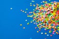 Frame made of colored confetti. Blue background. Royalty Free Stock Photo