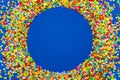 Frame made of colored confetti. Blue background. Royalty Free Stock Photo