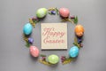 Frame made of colorful painted eggs and card with text Happy Easter on color background Royalty Free Stock Photo