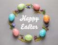 Frame made of colorful painted eggs and text Happy Easter on color background Royalty Free Stock Photo