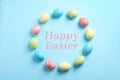 Frame made of colorful painted eggs and text Happy Easter on color background Royalty Free Stock Photo