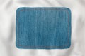 Frame made of denim fabric with yellow stitch on white silk with space for your text Royalty Free Stock Photo