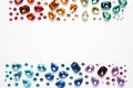 Frame made of different beautiful gemstones on white background. Space for text