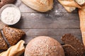 Frame made of different bread and white flour on wooden background Royalty Free Stock Photo