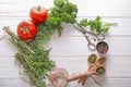 Frame made of different fresh herbs, spices, tomatoes and scissors on wooden background Royalty Free Stock Photo