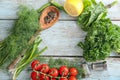 Frame made of different fresh herbs, spices, vegetables and lemon on wooden background Royalty Free Stock Photo