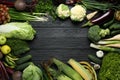 Frame made of different fresh ripe vegetables and fruits on black wooden table, flat lay with space for text. Farmer produce Royalty Free Stock Photo