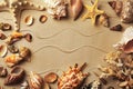 Frame made with sea shells on sand, flat lay. Space for text Royalty Free Stock Photo