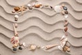 Frame made of different sea shells and stones on sand Royalty Free Stock Photo
