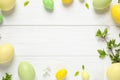 Frame made with Easter eggs on wooden background, flat lay. Space for text Royalty Free Stock Photo