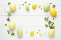 Frame made with Easter eggs on wooden background, flat lay. Space for text Royalty Free Stock Photo