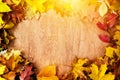 Frame made of fall leaves on wood. Autumn background Royalty Free Stock Photo