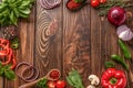 Frame made of fresh aromatic herbs, spices and vegetables on wooden background Royalty Free Stock Photo