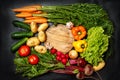 Frame made of fresh assorted vegetables on dark black background around wooden cutting board Royalty Free Stock Photo