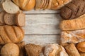 Frame made with fresh bread on wooden background, flat lay Royalty Free Stock Photo