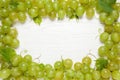 Frame made with fresh ripe juicy grapes on white wooden table, space Royalty Free Stock Photo