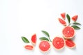 Frame made of grapefruits and leaves on white background, top view. Citrus fruits