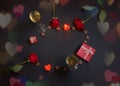 Frame made of heart shape chocolate candies, burning candles, glasses of champagne, red roses  and gifts. Concept of Valentine Day Royalty Free Stock Photo