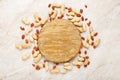 Frame made of nuts peanuts in shell and peeled peanuts with cutting board in the center on white marble background. Flat lay with Royalty Free Stock Photo