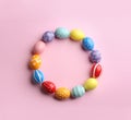 Frame made of painted Easter eggs on color background, top view. Royalty Free Stock Photo