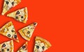 Frame made of pieces of pizza on a red background, the concept of a flyer advertising a restaurant or fast food. Flat lay, top